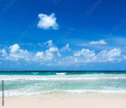 Beautiful beach with white sand. Tropical sea with cloudy blue sky . Amazing beach landscape