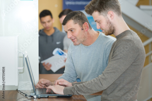 two men checking business solutions