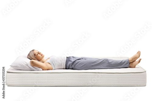 Young woman sleeping on a bed mattress