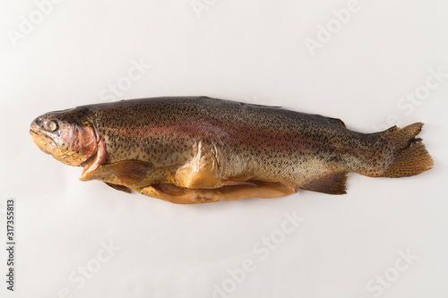 Cold smoked rainbow trout on a white background © oleghz