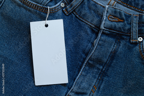 Картината върху платно Element of jeans pants with white tag label.