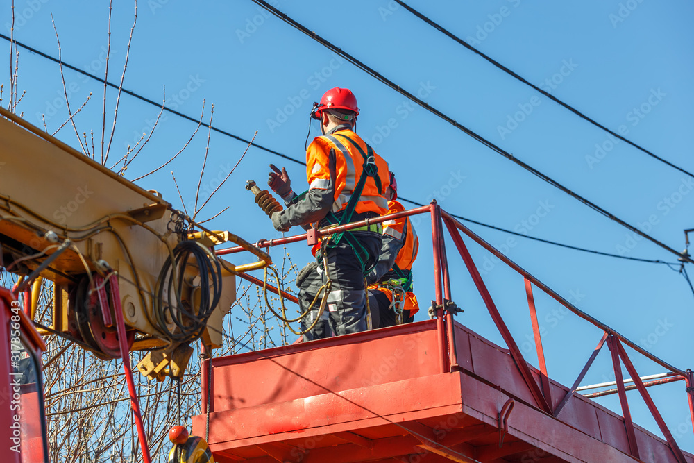 Working electrician looks at the power lines Working electrician looks at the power lines