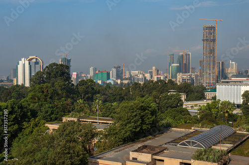 Addis Abeba. A view over the city from the Hilton Hotel. Massive construction of bank and office buildings in the business district of Addis Abeba with the green foreground and blue sky