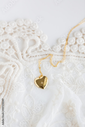 Gold heart necklace on lace