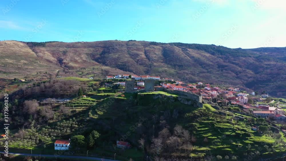 Aerial, pull back, drone shot, away from the castle of Linhares, on a sunny day, in Celorico da Beira, Guarda, Portugal Aerial, pull back, drone shot, away from the castle of Linhares, on a sunny day, in Celorico da Beira, Guarda, Portugal
