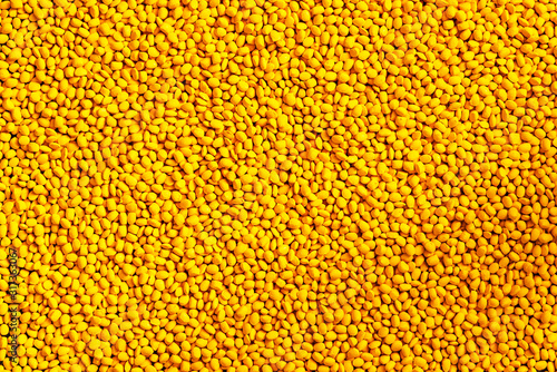 Yellow polymer dye in granules  background texture