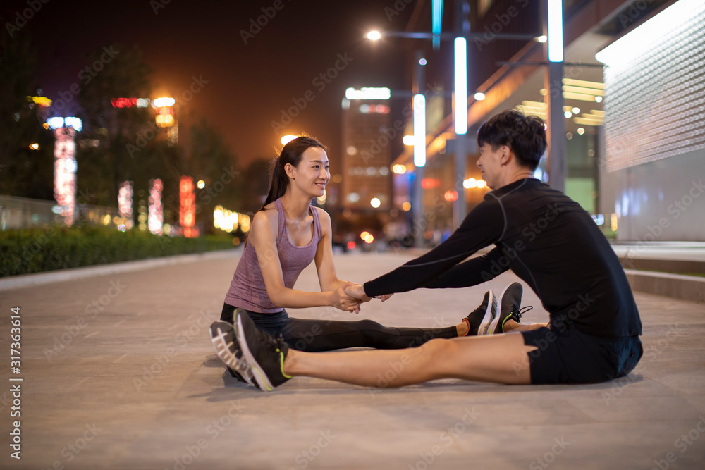 Young couple exercising at night Young couple exercising at night