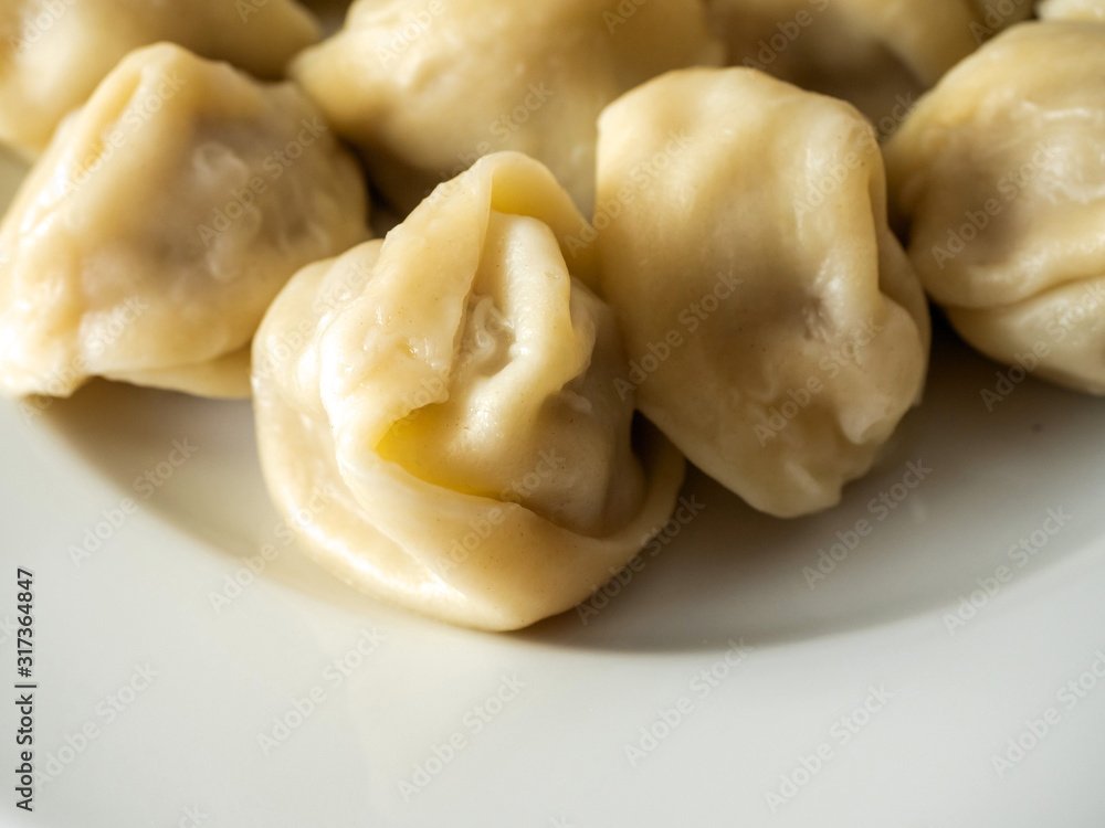 Portion of traditional Russian cooked dumplings on a white plate. Portion of traditional Russian cooked dumplings on a white plate.