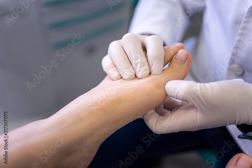 Podiatrist examining and treating patient