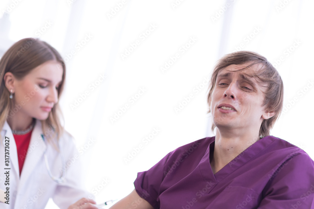 A male patient felt pain in his arm when a female doctor was injecting his arm. A male patient felt pain in his arm when a female doctor was injecting his arm.