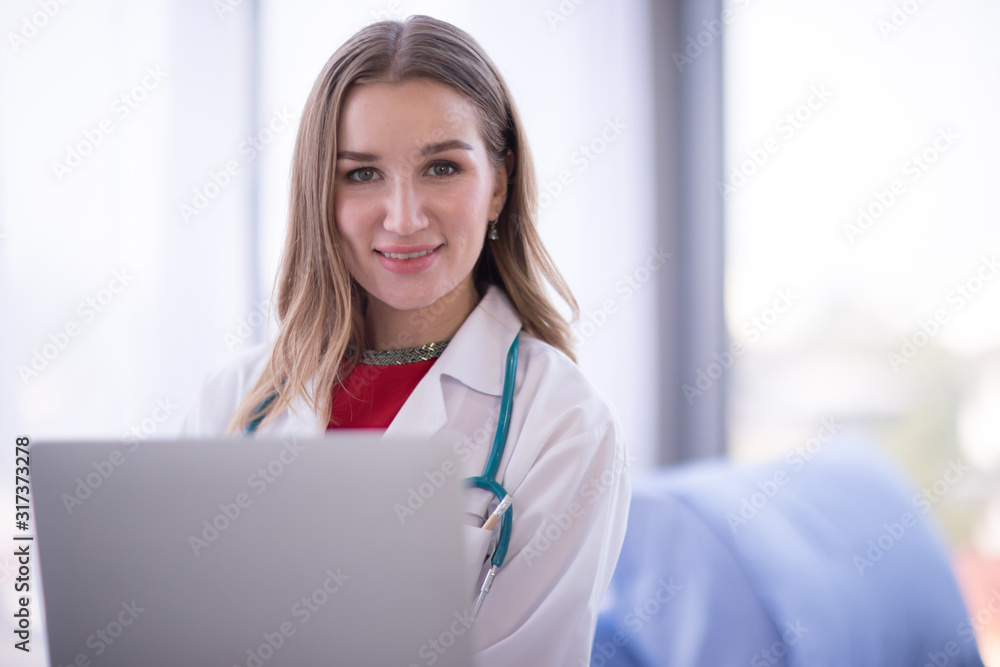 Portrait Of Female Doctor Wearing White Coat with stethoscope, smiling to camera Portrait Of Female Doctor Wearing White Coat with stethoscope, smiling to camera