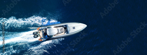 Fotografie, Obraz Aerial drone top down ultra wide photo of inflatable speed boat cruising in high