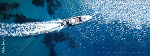 Slika na platnu Aerial drone top down ultra wide photo of inflatable speed boat cruising in high