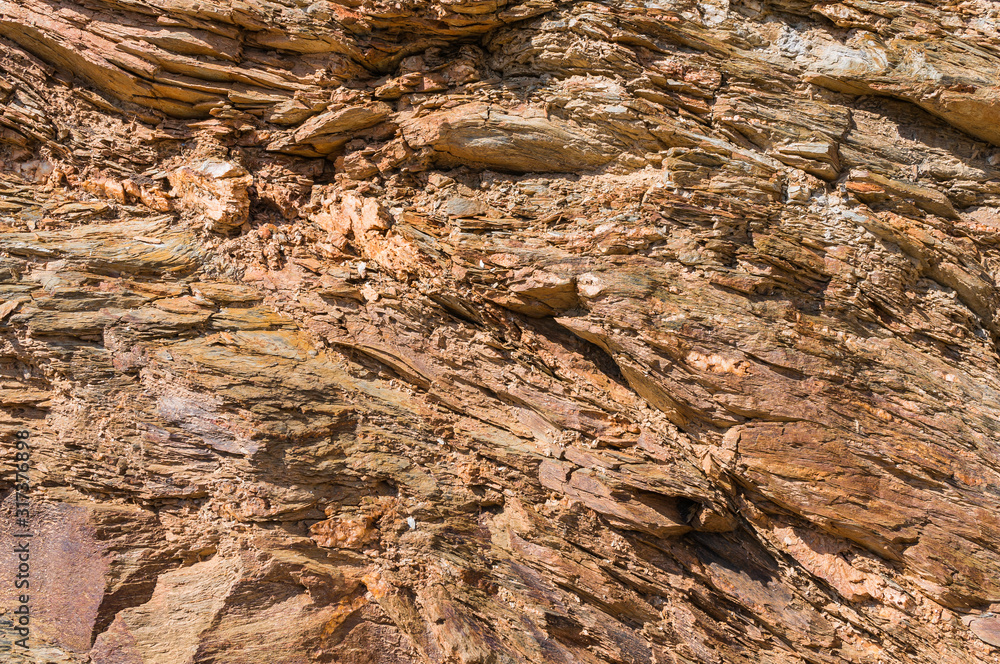 Natural background of brown layered sandstone. Rock on the seashore. Natural background of brown layered sandstone. Rock on the seashore.