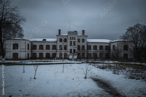 Dark and creepy abandoned haunted mental hospital in winter