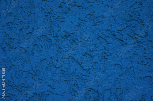 Rough surface prepared for painting. Classic blue texture plaster texture.