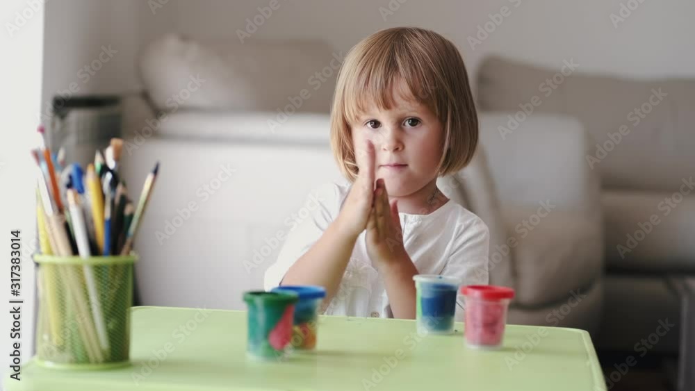 A girl has little hands. She plays with the plasticine. The kid is at home. A girl has little hands. She plays with the plasticine. The kid is at home.