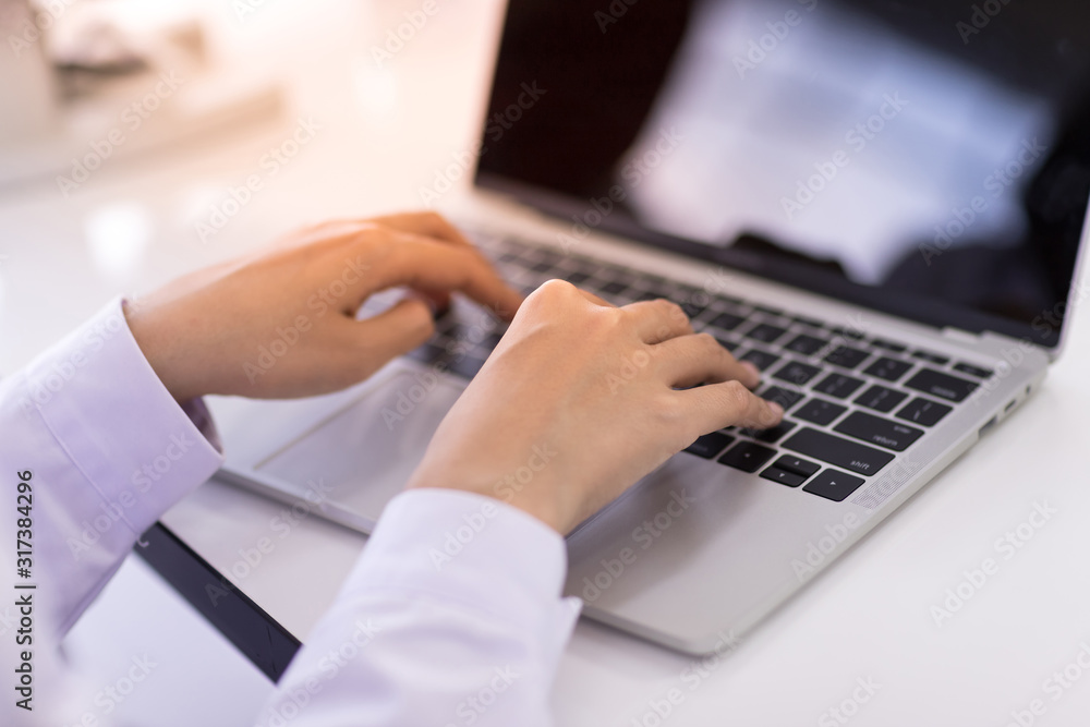 Hands typing on laptop keyboard Hands typing on laptop keyboard