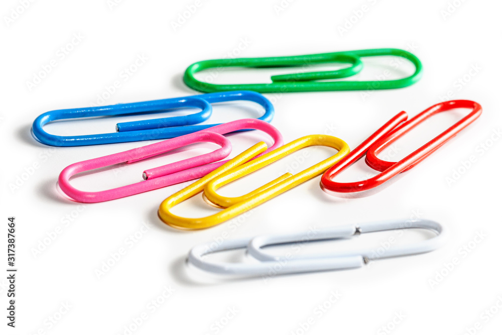 Many multicolored paper clips on a white background. Many multicolored paper clips on a white background.
