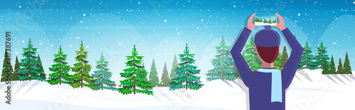 travel blogger using smartphone camera photographing snowy forest during hiking blogging live streaming wanderlust concept winter landscape background horizontal portrait vector illustration