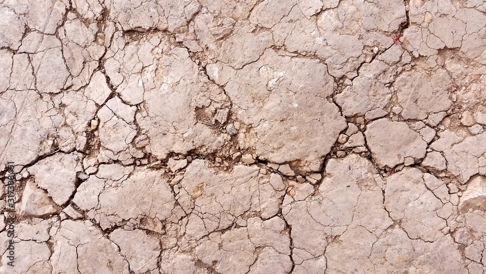 Fototapeta premium Photo of arid ground or close-up cracked land. Images of desert ground texture background from above. Royalty free stock picture.