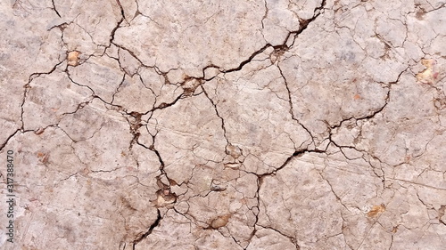 Broken or macro cracked. Photo of  soil during drought background. Hard shadows and  dried ground from top view. Royalty free stock photograph.