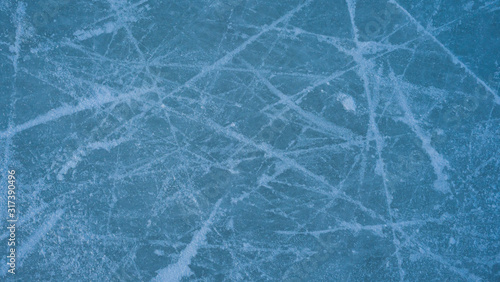 ice background with marks from skating and hockey, blue texture