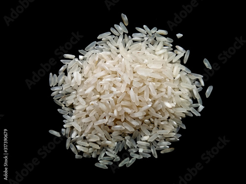 Abstract rice cloud and white rice explosion isolated on black background. pile rice isolated on black background.