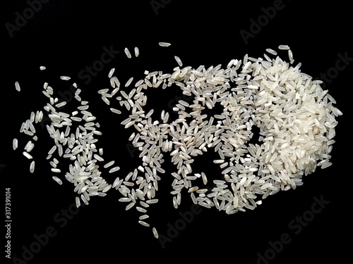 Fototapeta Naklejka Na Ścianę i Meble -  Abstract rice cloud and white rice explosion isolated on black background. pile rice isolated on black background.