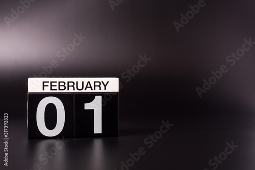 February 1st. Day 1 of february month, calendar on black background. Winter time. Leap-year