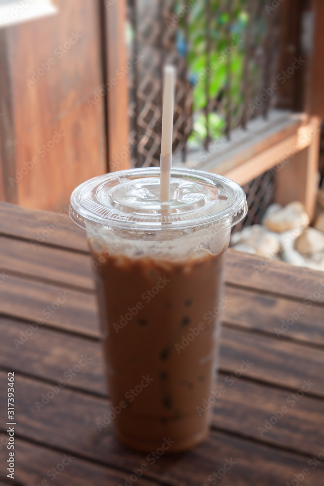 Iced coffee in coffee shop on wooden table Iced coffee in coffee shop on wooden table