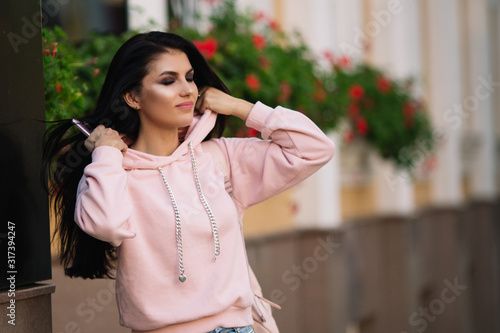 Beautiful model posing for the camera on the streets. © zadorozhna