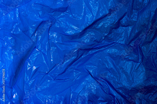 Surface of blue wrinkled plastic bag.
