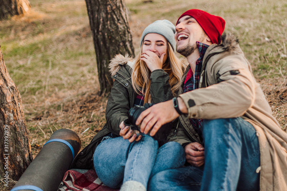 Travel couple camping with map in the forest. Concept of trekking, adventure and seasonal vacation. Travel couple camping with map in the forest. Concept of trekking, adventure and seasonal vacation.