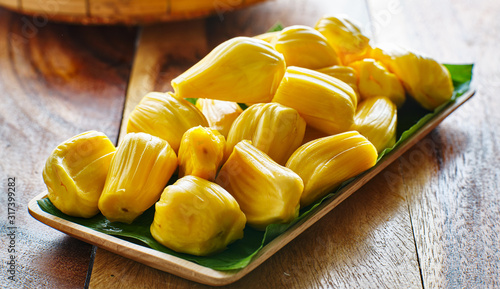 pile of peeled jackfruit on banana leaf serving tray,