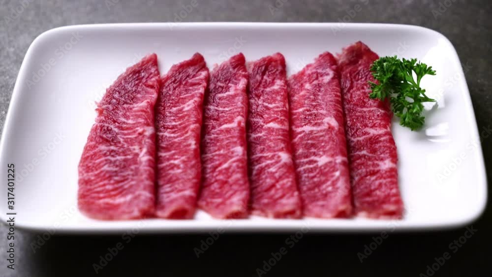 fresh beef raw sliced with marbled texture served for Sukiyaki and Shabu or Yakiniku fresh beef raw sliced with marbled texture served for Sukiyaki and Shabu or Yakiniku