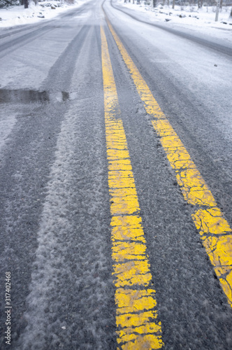 wintry mix and snow on a county road in winter © Michele