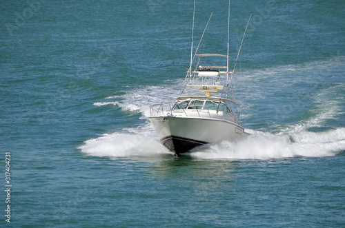 Speeding sport fishing boat leaving a wake trail on the florida intra-coastal waterway off Miami Beach.