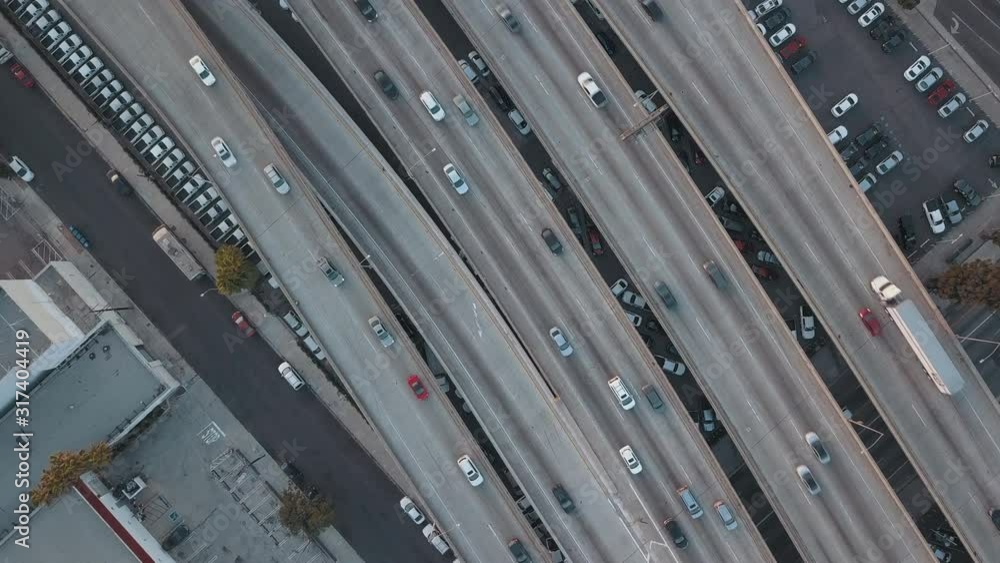 Aerial Drone Birdseye View Zooming Up out of Traffic Passing in Beautiful Busy Downtown Los Angeles overlooking Interstate 10 during Sunset Aerial Drone Birdseye View Zooming Up out of Traffic Passing in Beautiful Busy Downtown Los Angeles overlooking Interstate 10 during Sunset