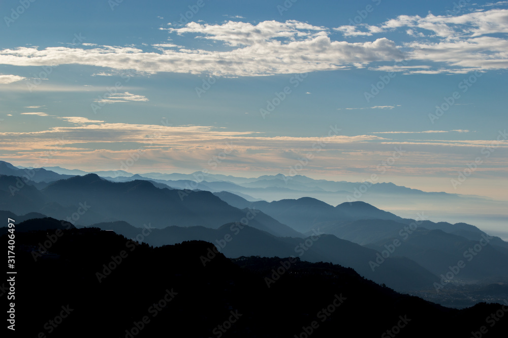 Layers of mountains in sunrise seen from the top of Mussoorie, Uttarakhand, India