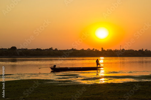 A fisher man on the river during sunset