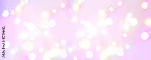 Banner. Abstract background of glowing balls of lights on a soft pink background. Horizontal blurred background