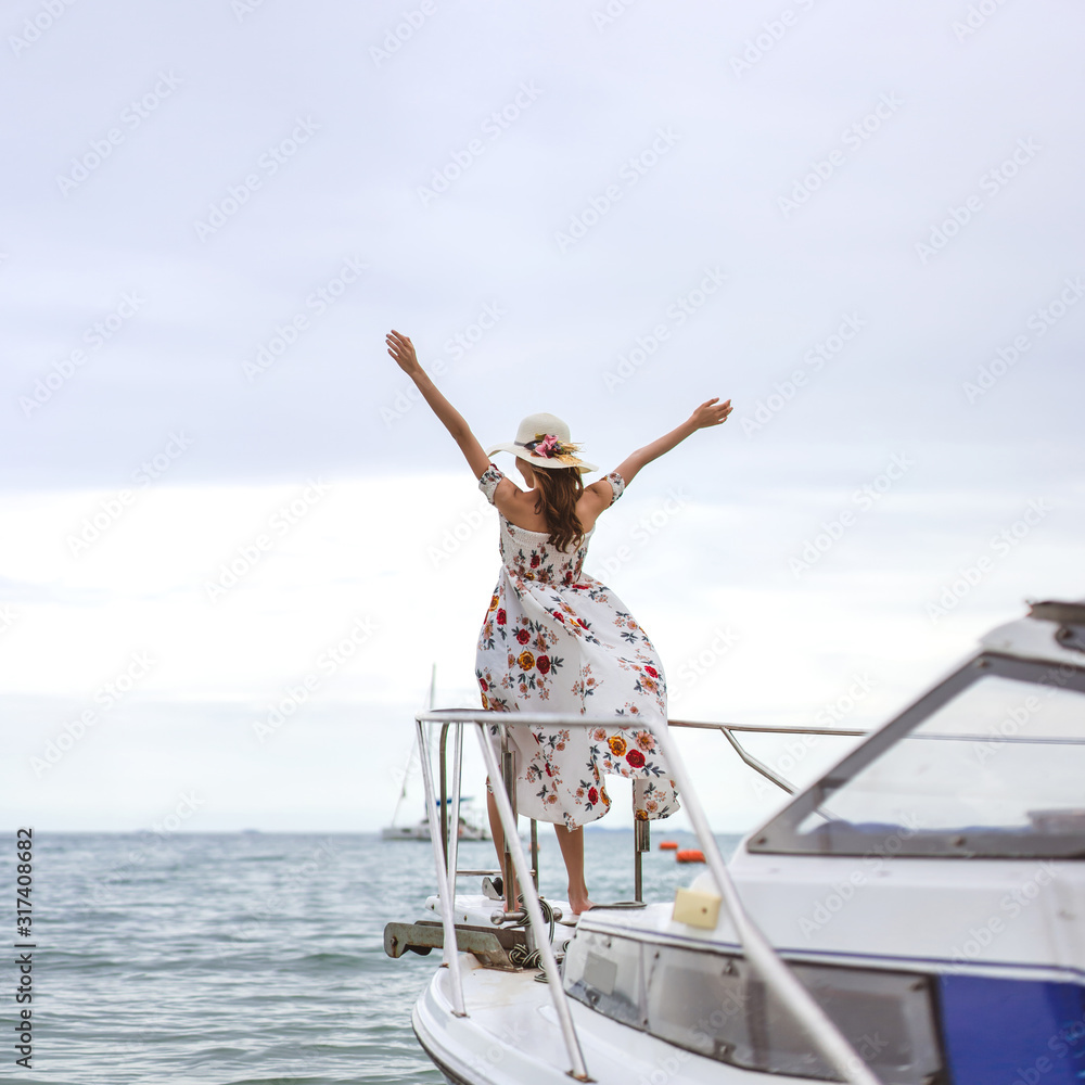 Young Asian traveller woman stand relax on speed boat and open arm up. Young Asian traveller woman stand relax on speed boat and open arm up.