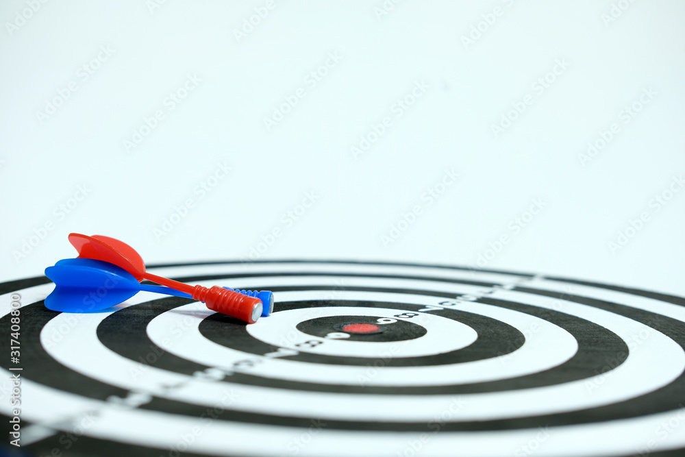 Wooden dartboard with red blue arrow on white background Wooden dartboard with red blue arrow on white background