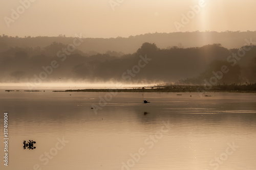 Sunrise over the lake with reflection mist on the water  Landscape sunrise concept