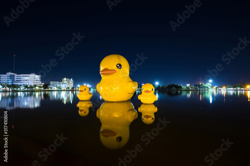 Fotografie Giant yellow ducks at night, The Giant yellow ducks is the most popular in Nong Prajak public park