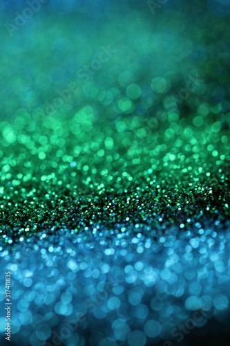 glitter background.blue and Green shiny gloss layout. Green and blue striped glitter with shining bokeh.Vibrant background with twinkle lights. 