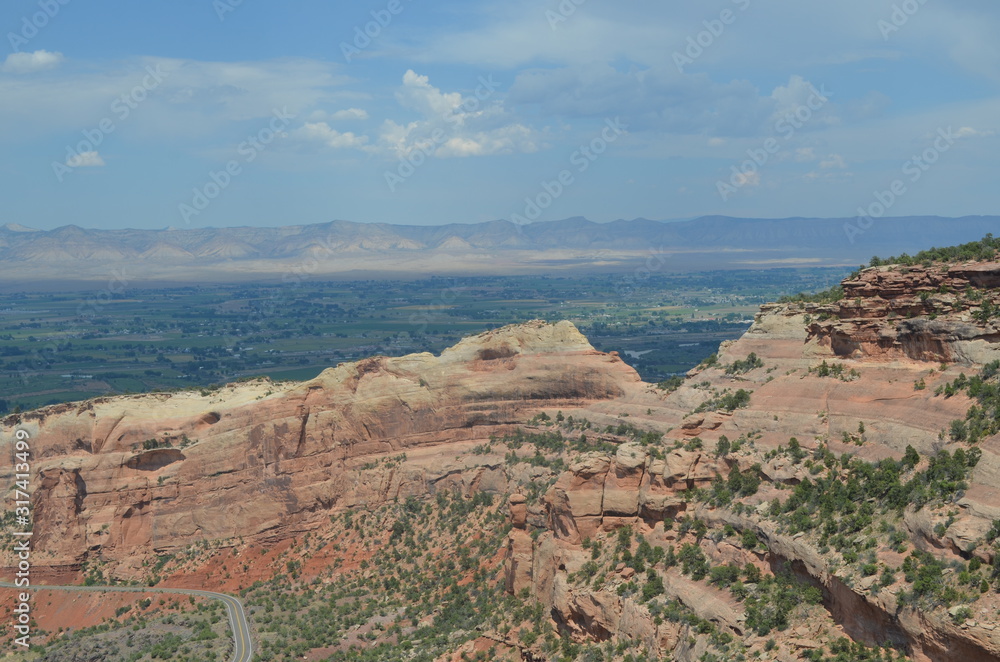Summer in Colorado: Looking Across Rim Rock Drive and Fruita Canyon to Grand Valley and the Book Cliffs from Fruita Canyon View in Colorado National Monument