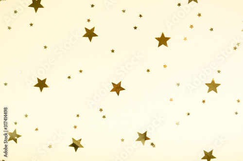Golden stars composition on beige background  party and celebration decoration.