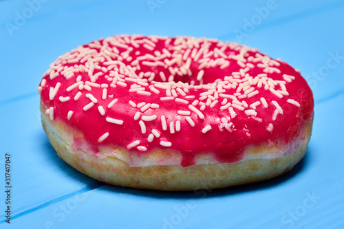 pink glazed donut on a blue background